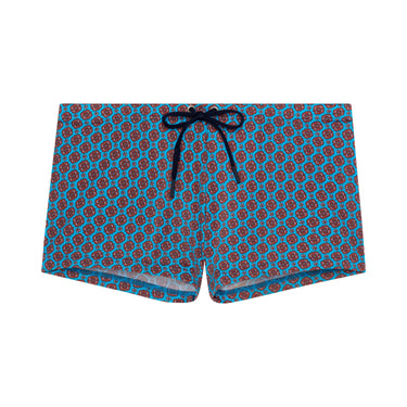 Blue swim shorts with red pattern on a white background